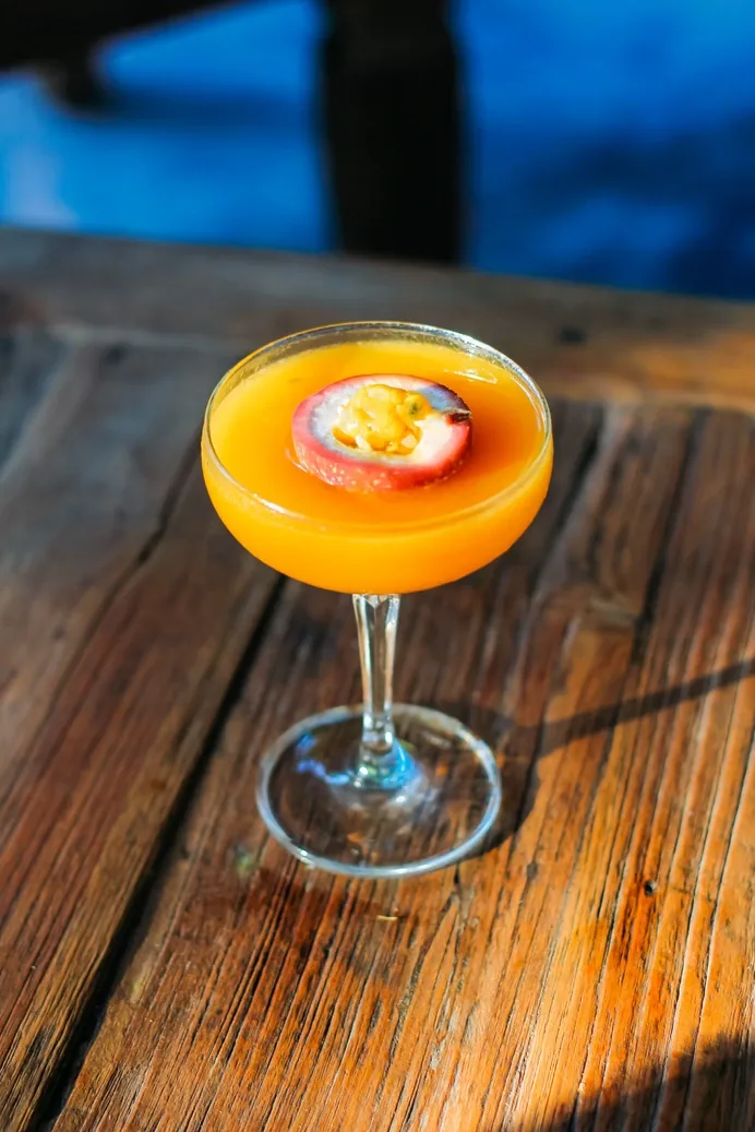 A passion fruit martini on a table at Seed in Bingin