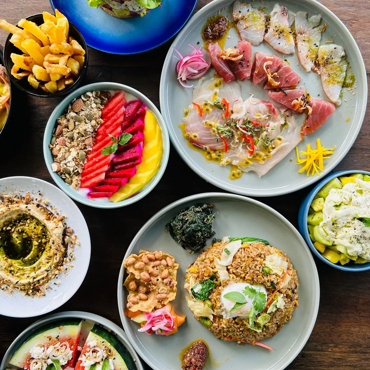 A breakfast spread of many dishes laid out on a table at Seed in Bingin